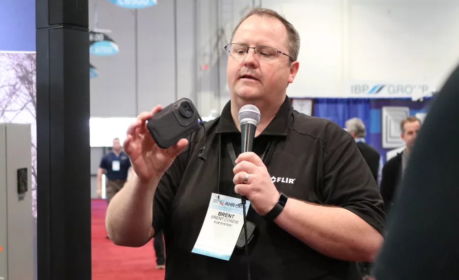 Brent Condie from FLIR Systems shows off one of the company&rsquo;s latest infrared viewing devices and explains its benefits to contractors