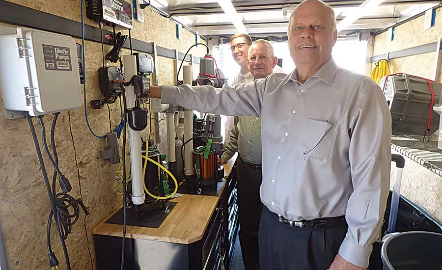 Back to front, Mark Mayer, Vollmer and Wanberg demonstrate Liberty Pumps products
