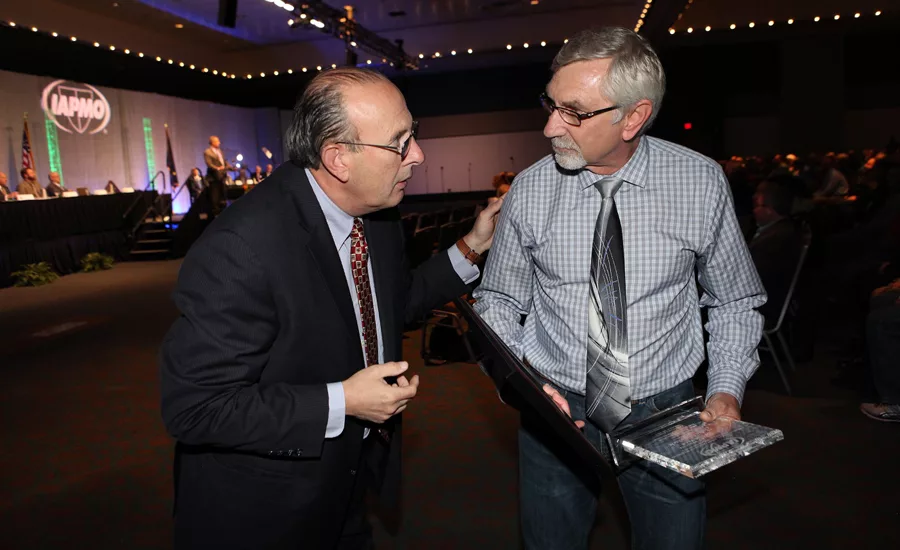 IAPMO CEO Russ Chaney (left) congratulates John Parizek