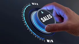 Hand turning a "SALES" knob to Maximum