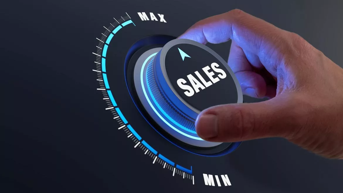 Hand turning a "SALES" knob to Maximum