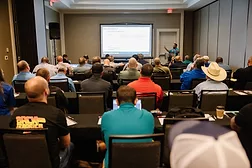 Attendees of the TSA Conference watching a presentation. 