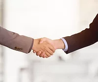 Two people shaking hands.