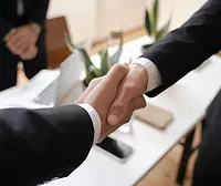 Two people shaking hands.