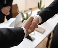 Two people shaking hands.