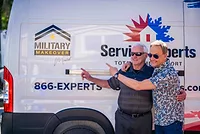 Mike Biederman and Art Edmonds standing in front of a Service Experts truck with the logo for Military Makeover. 