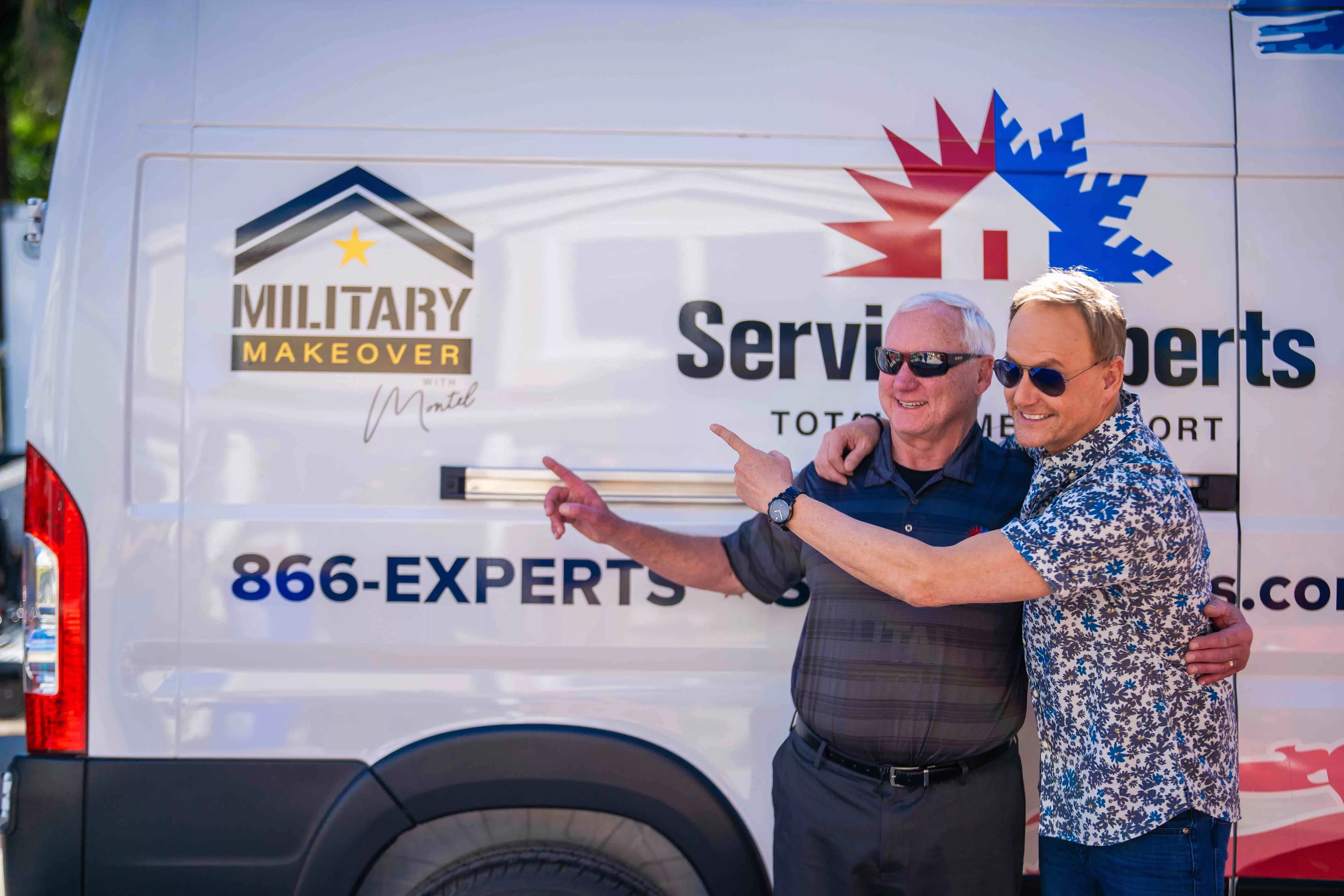 Mike Biederman and Art Edmonds standing in front of a Service Experts truck with the logo for Military Makeover.