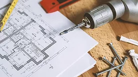 A sketch of a house, surrounded by tools. 