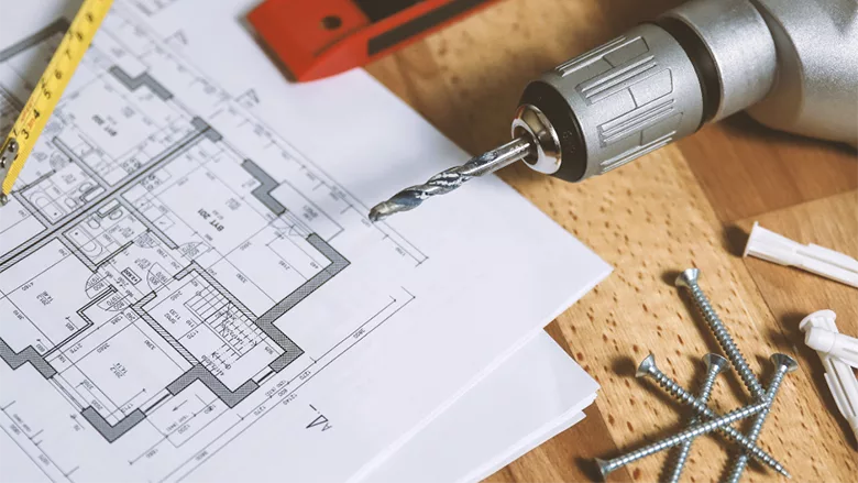 A sketch of a house, surrounded by tools. 