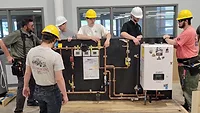 NIBCO donates training boards to support the next generation of skilled trades professionals Trade students working with the training boards.