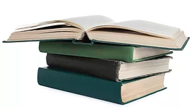 Stack of many old hardcover books isolated on white