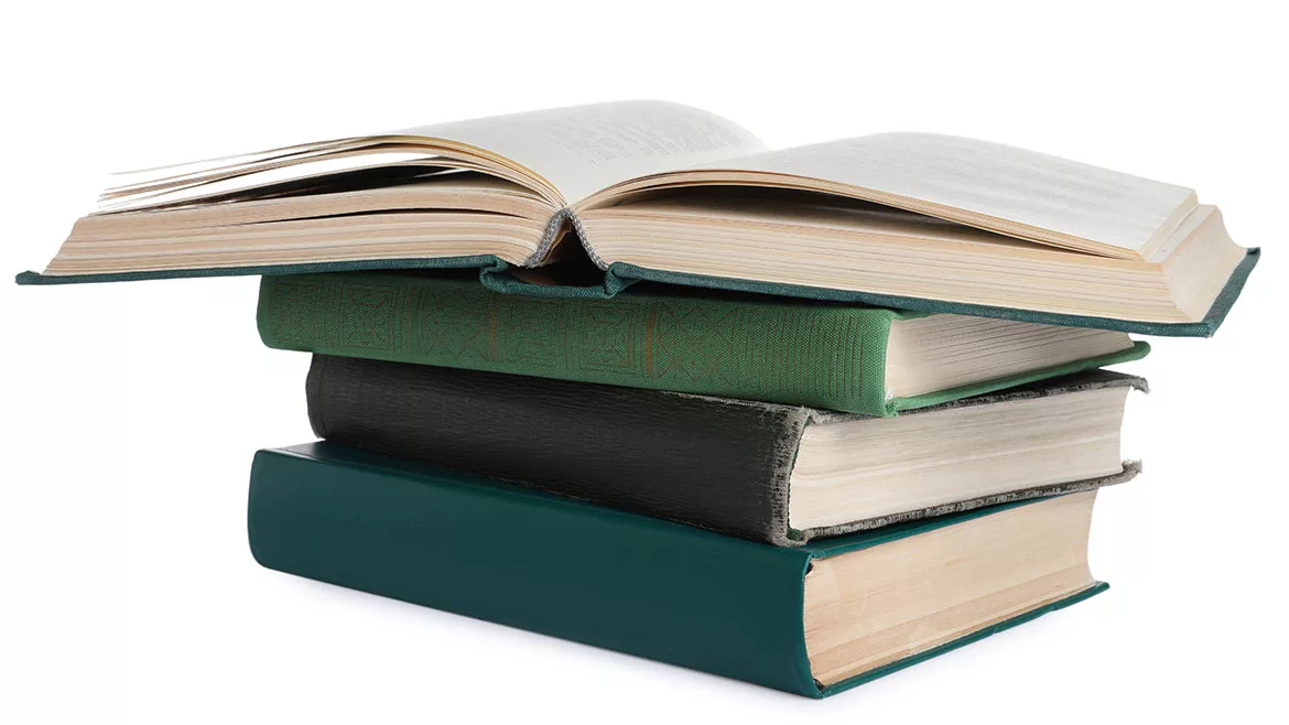 Stack of many old hardcover books isolated on white