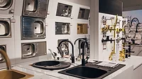 Different types of sinks and faucets in a home appliance store