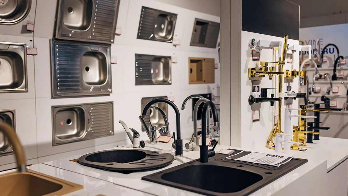 Different types of sinks and faucets in a home appliance store