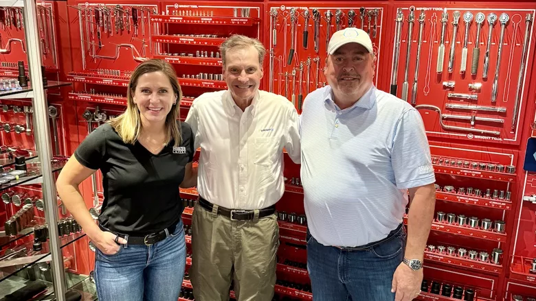 Members of the Rouzer Group in front of several tools. 