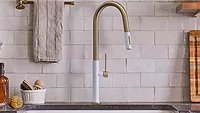 The Lenova K250 kitchen faucet in white PVD and brushed brass. 
