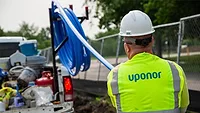 GF supports development of Veteran Village, a new community for Minnesota veterans A person in a hardhat and a construction vest with "Uponor" on the back.