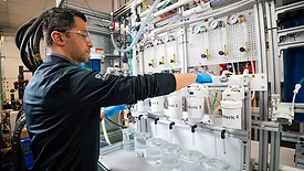 A GE Appliances lab engineer prepares to test third-party water filters against our genuine GE water filters inside the development lab at Appliance Park in Louisville, KY. 