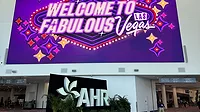 Welcome to Fabulous Las Vegas marquee in shades of purple above the AHR sign.