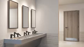 A restroom with Sloan accessories. 