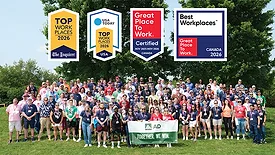 The AD team pictured with the logos for several workplace awards. 