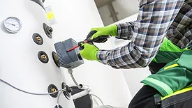Large Residential Water Heating Boiler Maintenance Performed by Professional HVAC Technician