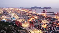 2024 PHCP-PVF Industry Forecast feature. Night scene of container terminal by water.