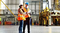 Eye on Safety column feature image of two warehouse workers SHT February 2024 Eye on Safety column feature image of two workers inside large warehouse.