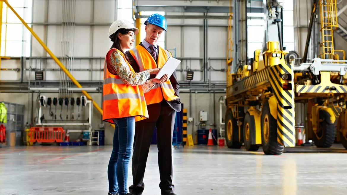 SHT February 2024 Eye on Safety column feature image of two workers inside large warehouse.