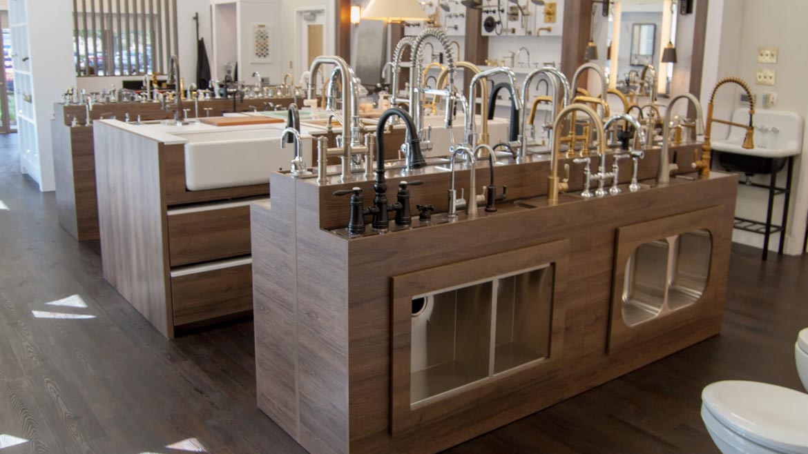 SHT February 2024 Sandpiper Supply Remodel feature. Image of faucet and sink displays in the showroom.