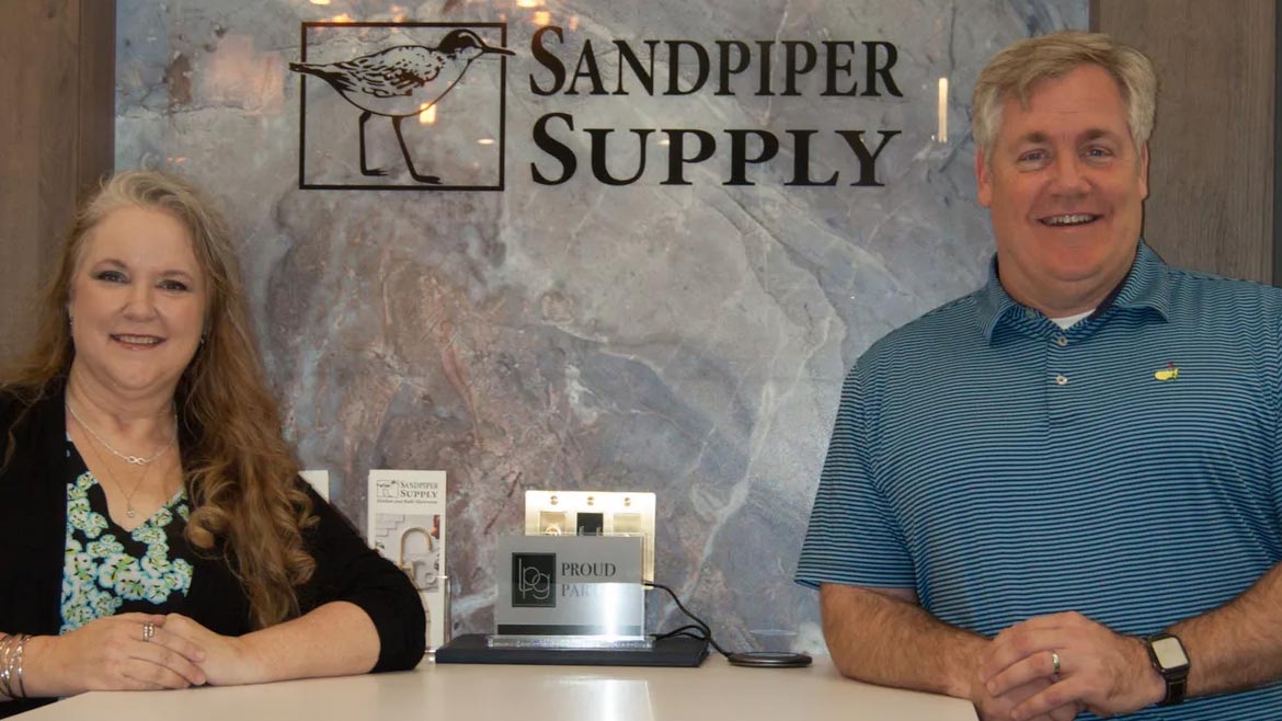 SHT February 2024 Sandpiper Supply Remodel: Christy Ellis and Chat Howard Jr. posing in front of the company sign.