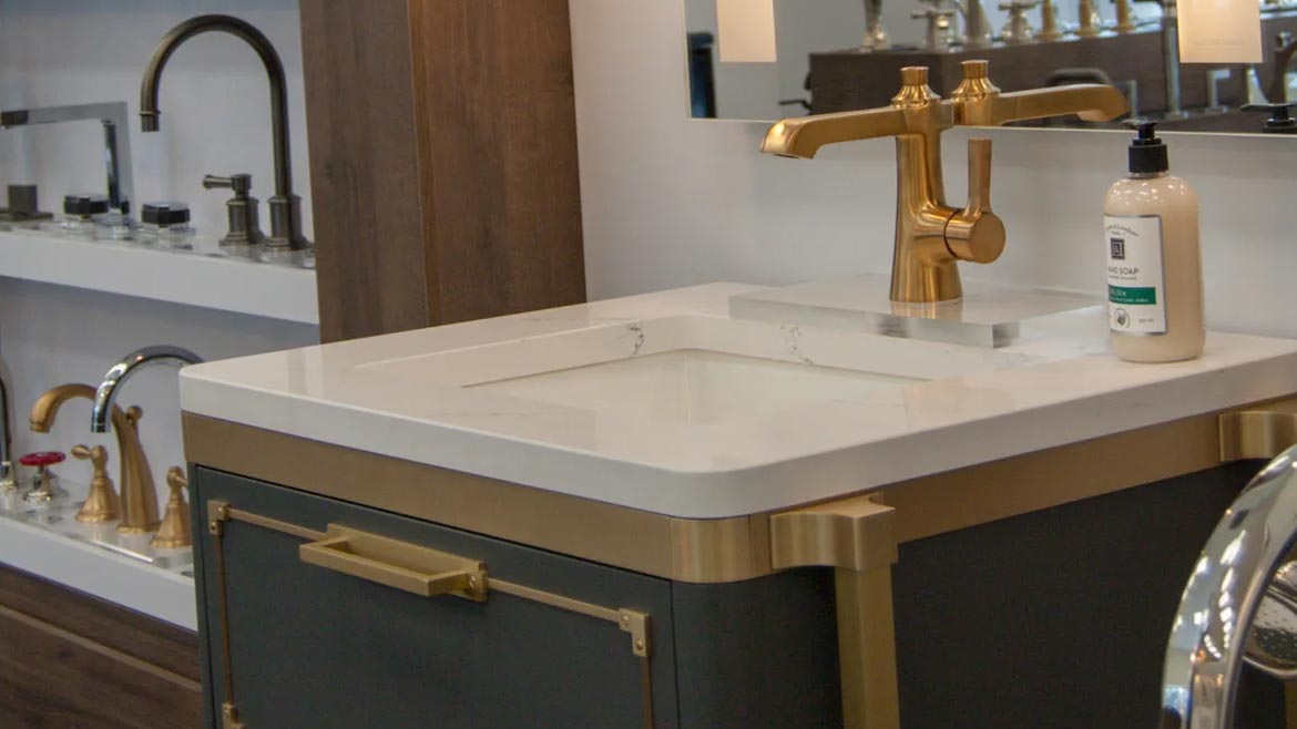 SHT February 2024 Sandpiper Supply Remodel: Faucets on a shelf display and a sink with a gold faucet and mirror.