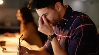 March 2024 Eye on Safety column feature image of stressed man March 2024 Eye on Safety column feature image of stressed man holding glasses and rubbing his eyes with a blurred image of a woman in the background.