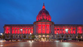 ASA News feature image of San Francisco City Hall in the evening, glowing red