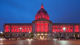 ASA News feature image of San Francisco City Hall in the evening, glowing red