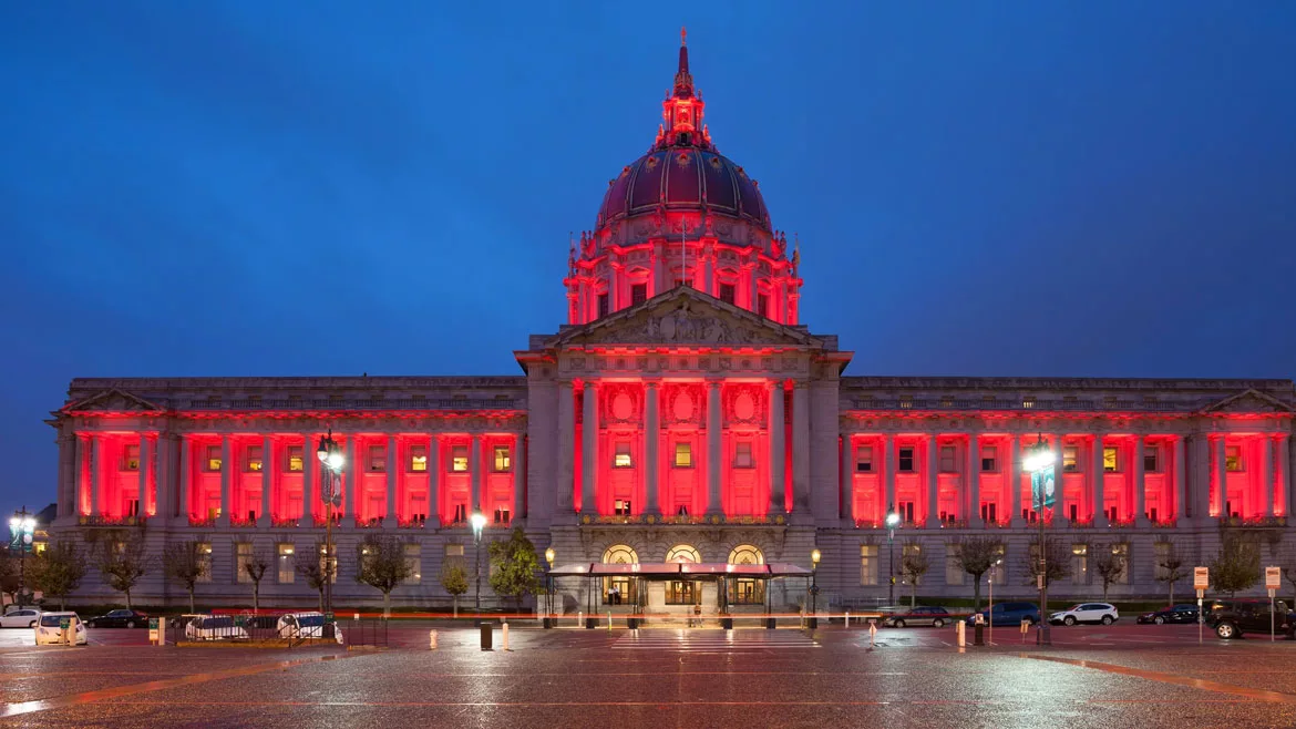 ASA News feature image of San Francisco City Hall in the evening, glowing red