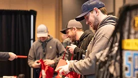 Pacific's ACHR Trade Expo attendees picking up swag.