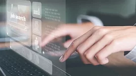 Hands on keyboard with job search virtual screen floating above