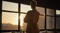 ASA President's Letter feature image of businesswoman (in shadow) looking out of the window.