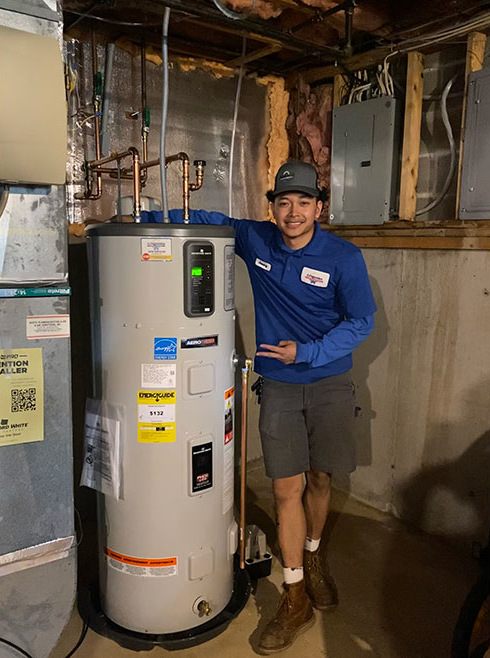 Installer posing next to Aerotherm installation.