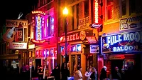Nashville's Music City at night and lit up by the neon signs.