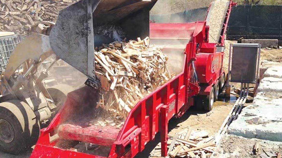 Wood scraps being loaded onto a truck bed