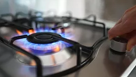 Close up of gas stove burner being turned on.