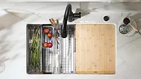 Overhead view of a sink. Overhead view of a sink with a vegetable rack and chopping board.