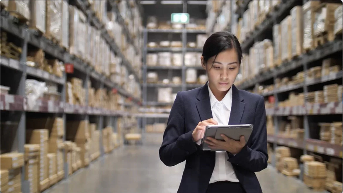 Businesswoman using Digital tablet in warehouse.