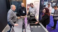 KBIS event attendees at a kitchen faucet display.