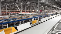 A large warehouse with multiple conveyor systems A large warehouse with multiple conveyor systems moving boxes and packages.