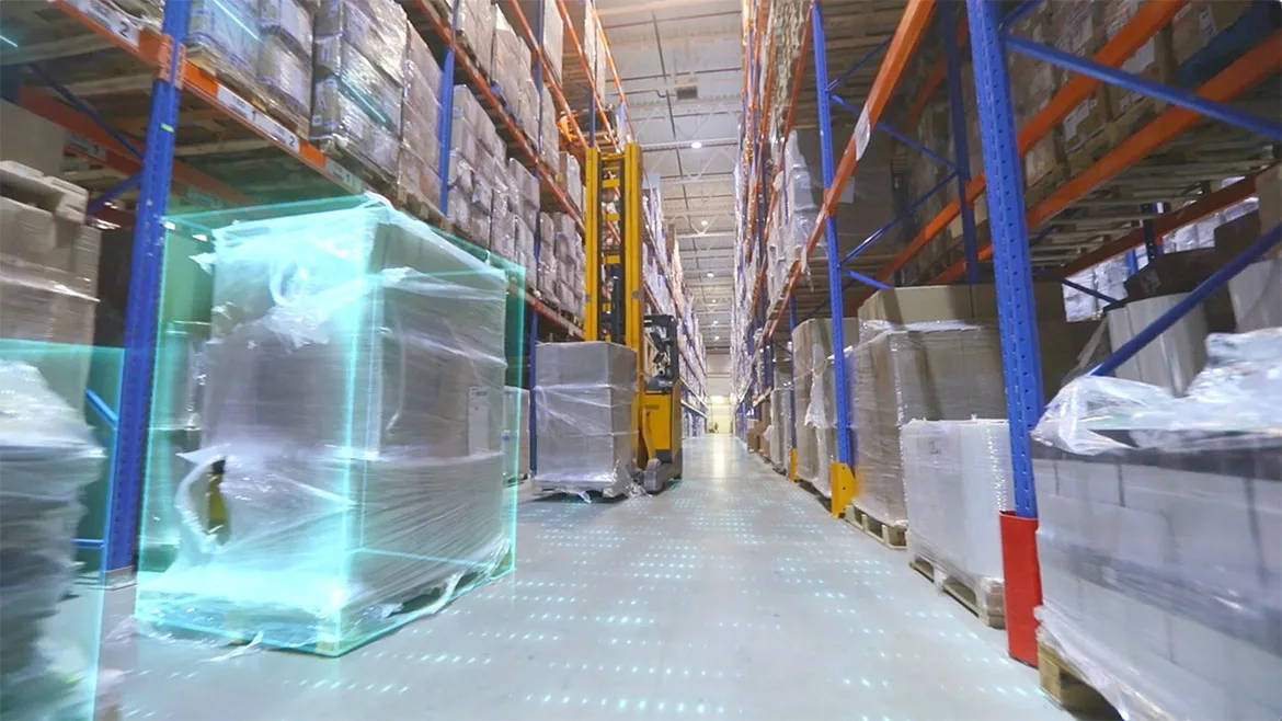 Screenshot from video of a forklift in a modern warehouse.
