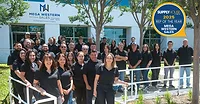 The Mega Western Sales Customer Service Team posing for a group photo outside their office building.