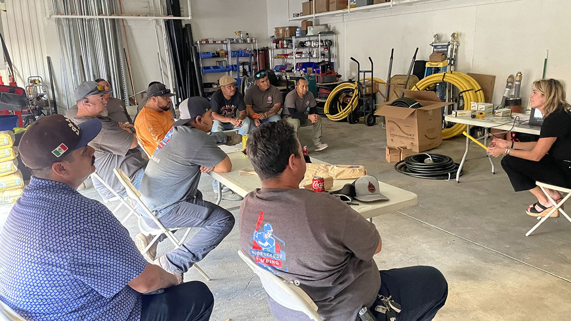 Workers seated in folding chairs at a jobsite product training offered by Mega Western Sales.